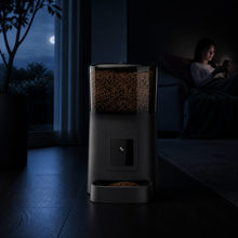 Black Arelio Feed One shown in a calm low-light room for night camera monitoring