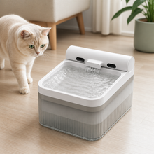 A cat approaching the Arelio Flow wireless pet fountain in a modern home